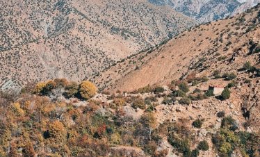 a view of a mountain range with a house in the foreground