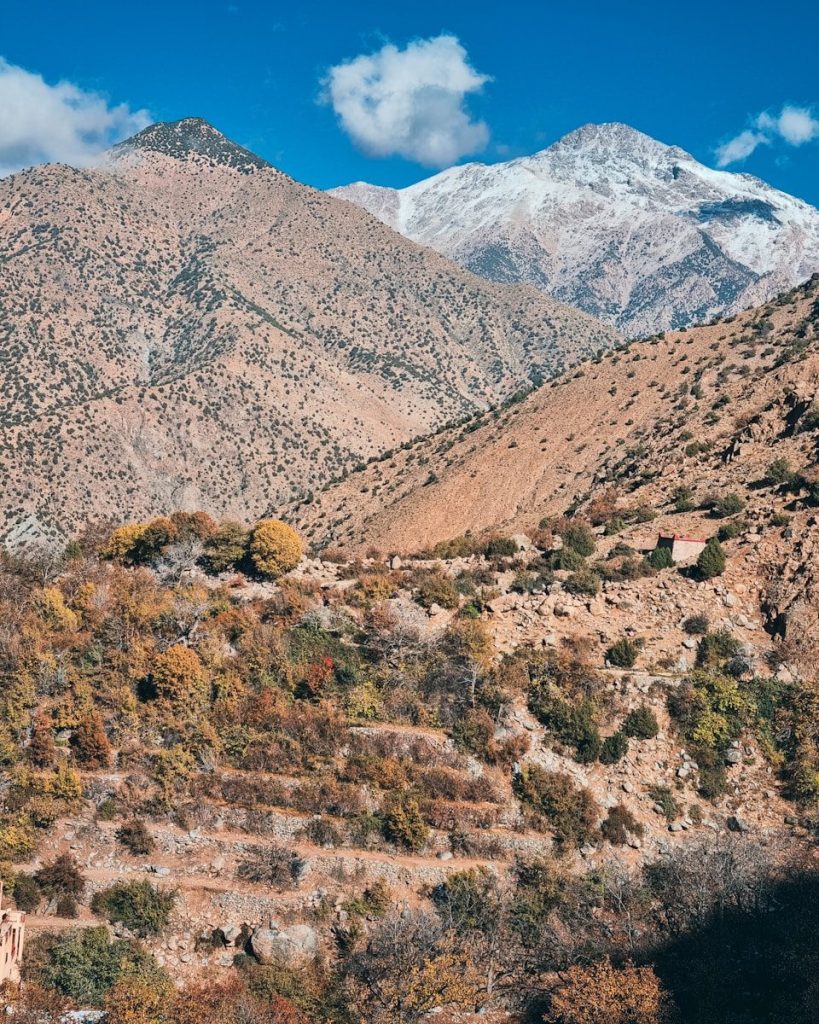 a view of a mountain range with a house in the foreground
